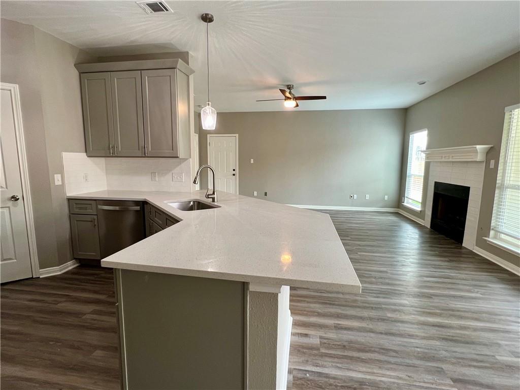 1706 Winners Ribbon Circle Pflugerville, TX 78660 - Photo 6 of 21 a view of a kitchen center island wooden floor and staircase