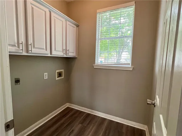 a view of a room with wooden floor and a window
