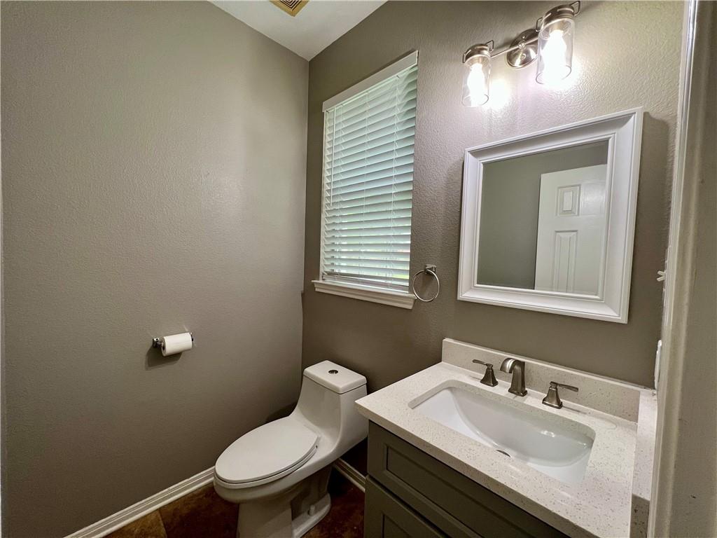 1706 Winners Ribbon Circle Pflugerville, TX 78660 - Photo 9 of 21 a bathroom with a sink vanity mirror and toilet