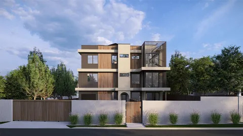 an aerial view of a house with wooden fence