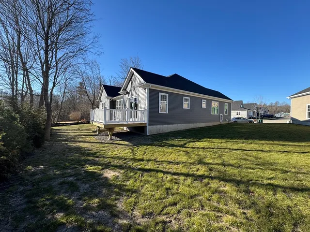 a front view of a house with a garden and a yard