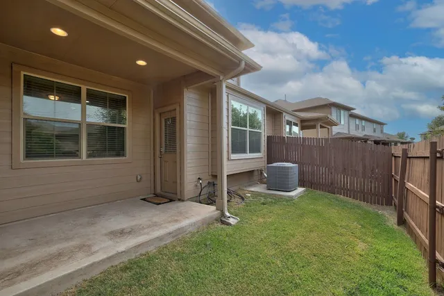 a view of a house with backyard and porch