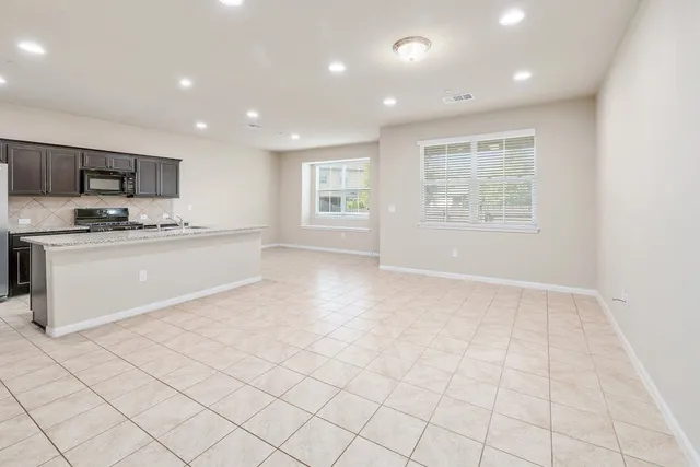 a kitchen with stainless steel appliances granite countertop a sink and a stove top oven