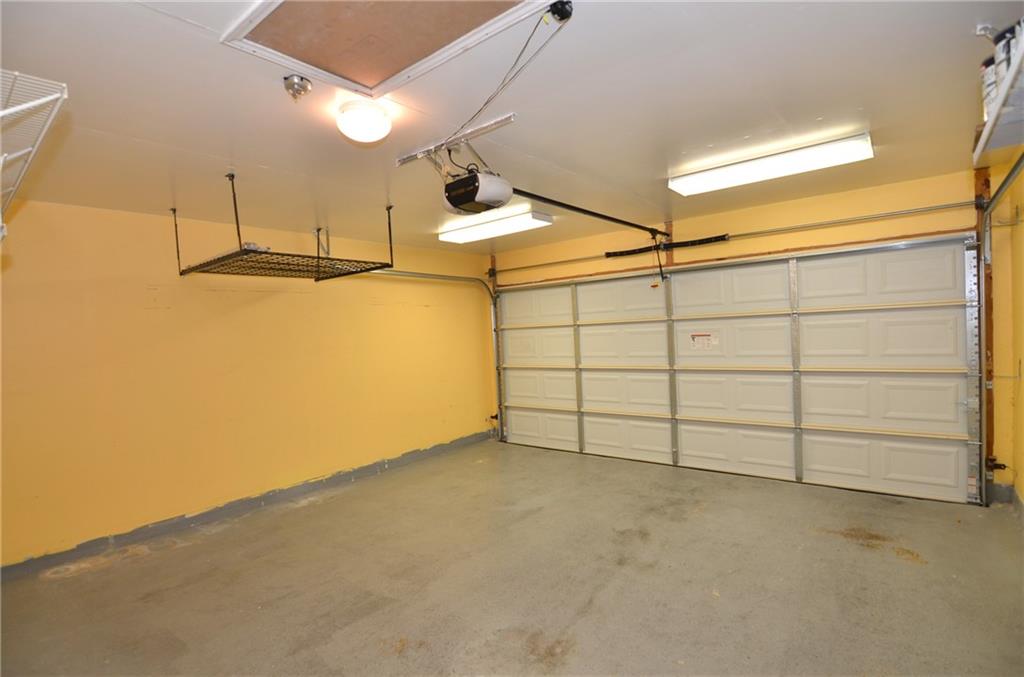 3609 Ruby Red Drive Austin, TX 78728 - Photo 18 of 21 Garage featuring a garage door opener and baseboards