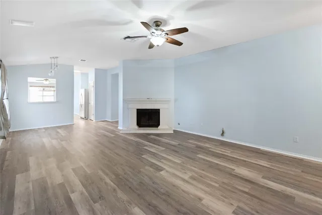 wooden floor in an empty room with a fireplace