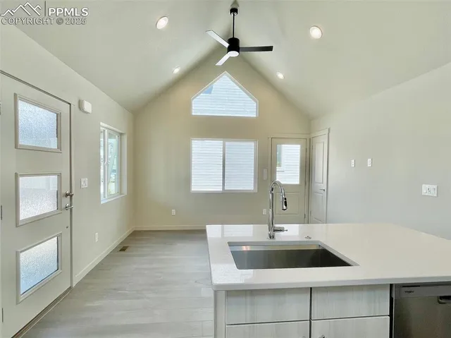 a kitchen with a sink and chandelier
