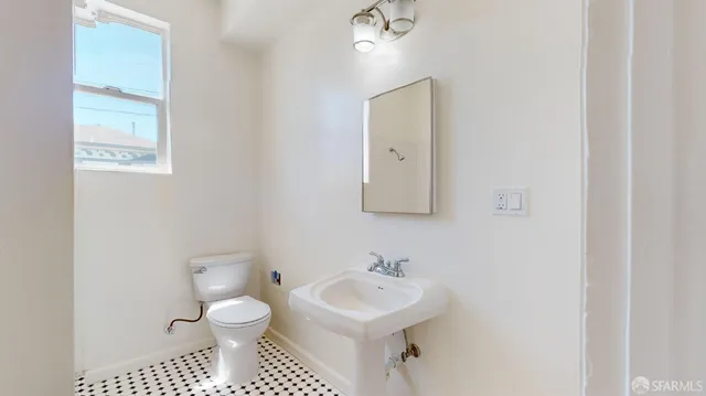 a white toilet sitting next to a bath tub