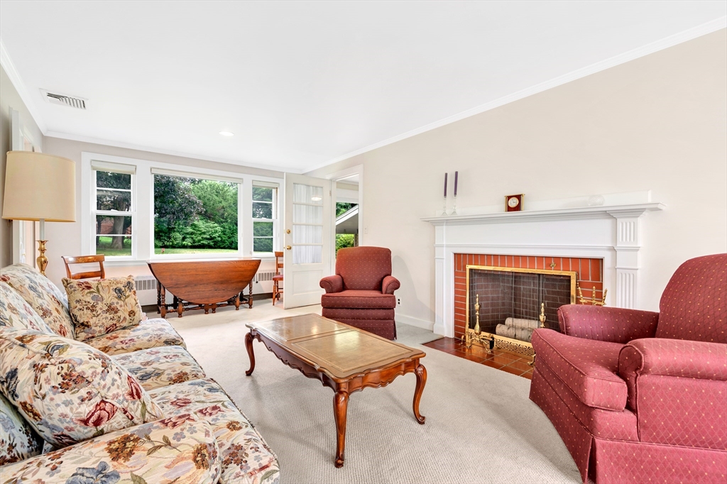 21 Gleason Road Lexington, MA 02420 - Photo 16 of 42 a living room with furniture fireplace and window