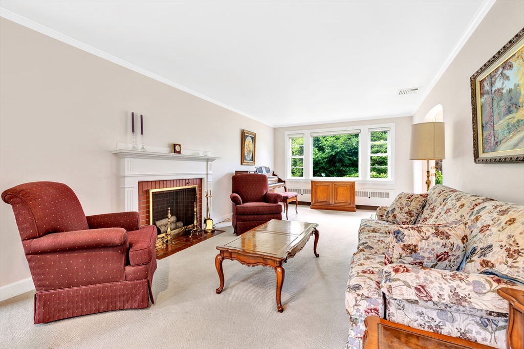 21 Gleason Road Lexington, MA 02420 - Photo 17 of 42 a living room with furniture a fireplace and window
