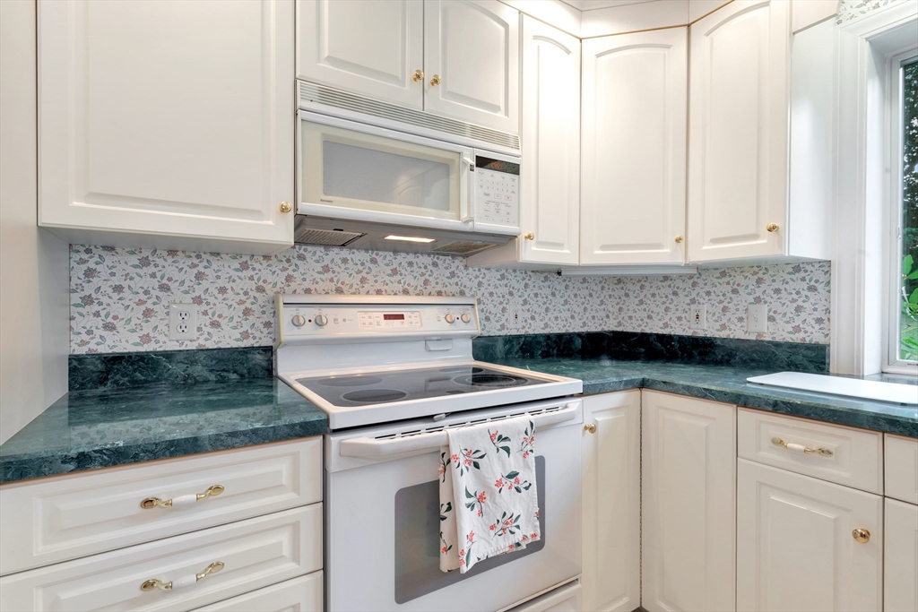 21 Gleason Road Lexington, MA 02420 - Photo 22 of 42 a kitchen with granite countertop a sink stove and cabinets