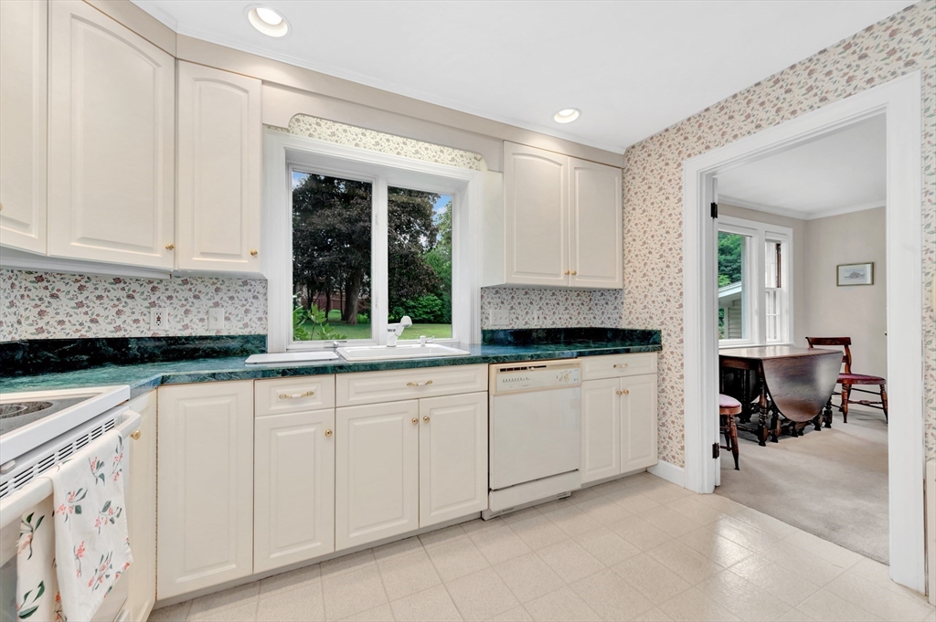 21 Gleason Road Lexington, MA 02420 - Photo 24 of 42 a kitchen with granite countertop white cabinets and white appliances