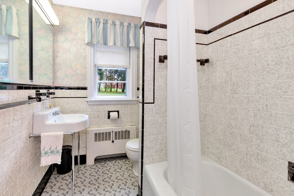 21 Gleason Road Lexington, MA 02420 - Photo 28 of 42 a bathroom with a sink a mirror and a bathtub