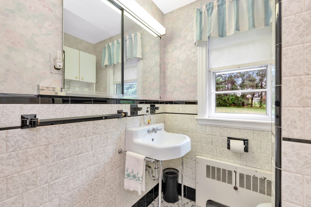 21 Gleason Road Lexington, MA 02420 - Photo 29 of 42 a bathroom with a sink and a mirror