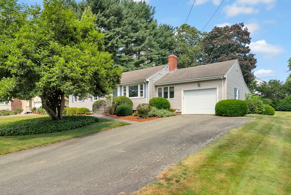 21 Gleason Road Lexington, MA 02420 - Photo 3 of 42 a front view of a house with a yard and trees