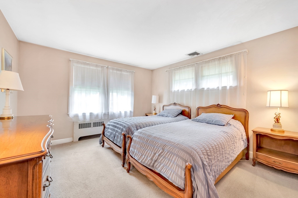 21 Gleason Road Lexington, MA 02420 - Photo 32 of 42 a bedroom with a bed and lamp