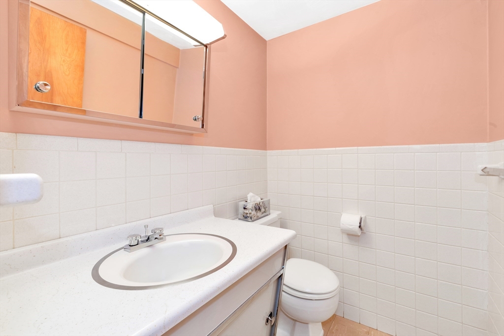 21 Gleason Road Lexington, MA 02420 - Photo 38 of 42 a bathroom with a sink a toilet and mirror