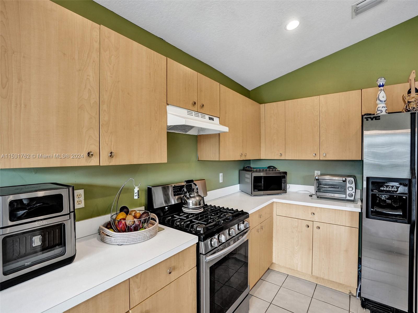 Greenacres Greenacres, FL 33413 - Photo 12 of 61 a kitchen with cabinets appliances and a sink