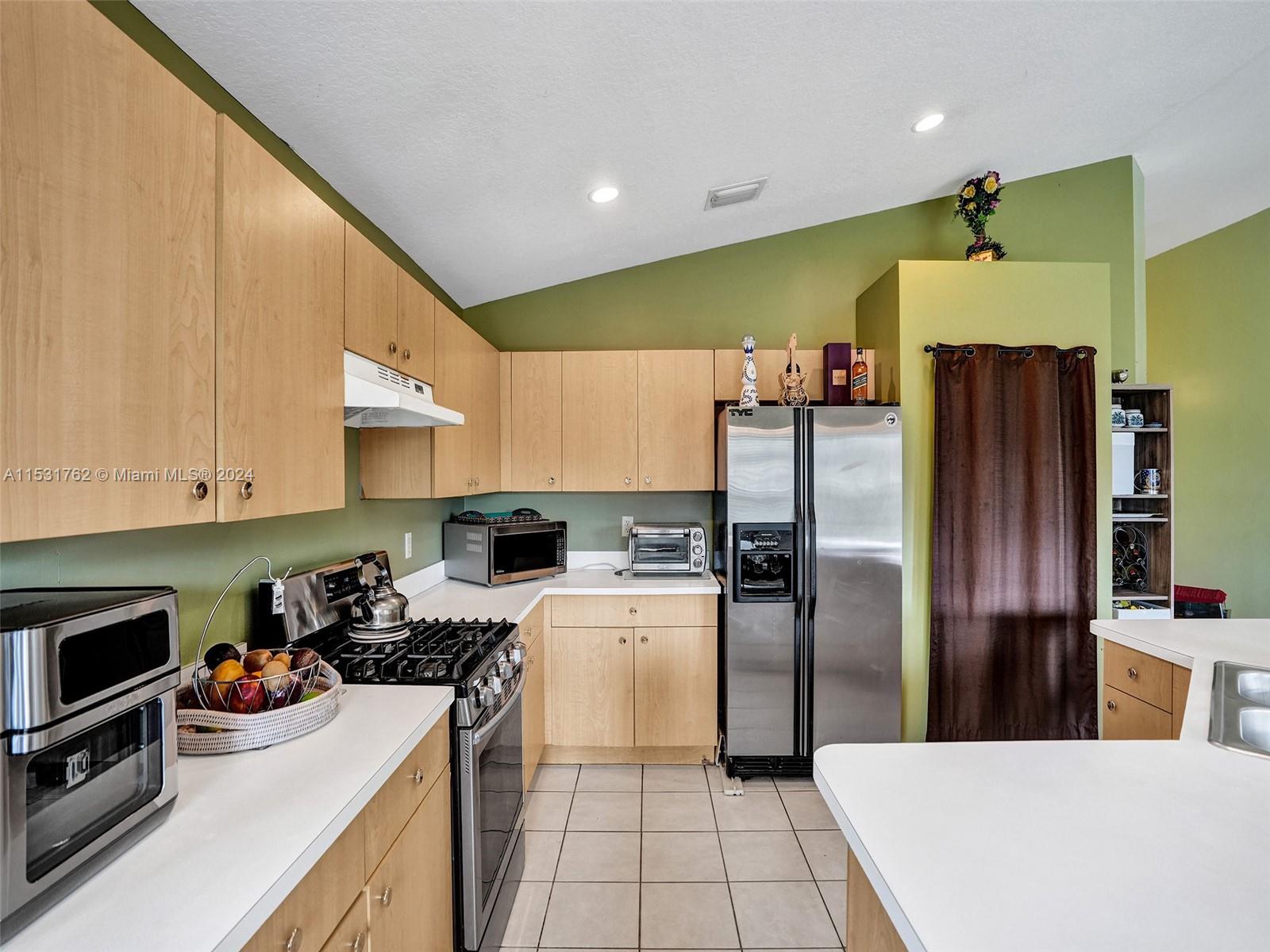 Greenacres Greenacres, FL 33413 - Photo 14 of 61 a kitchen with a refrigerator and a stove top oven