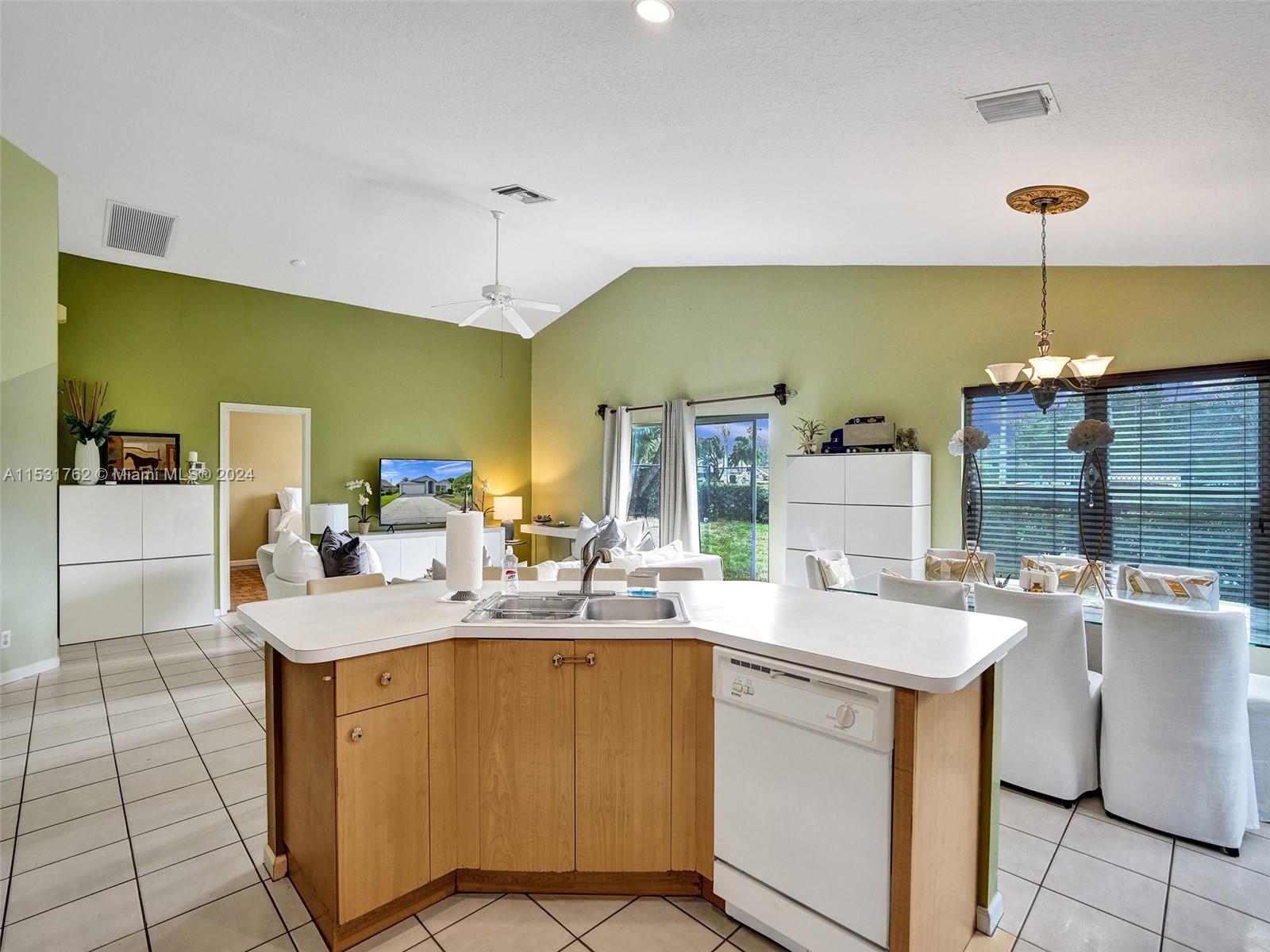 Greenacres Greenacres, FL 33413 - Photo 15 of 61 a kitchen with a sink appliances and cabinets