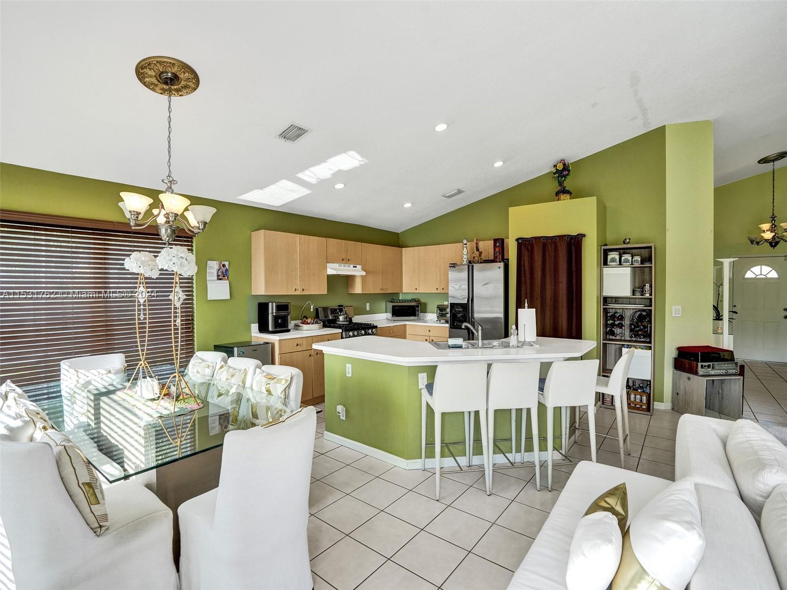 Greenacres Greenacres, FL 33413 - Photo 17 of 61 a living room with kitchen island furniture and a chandelier