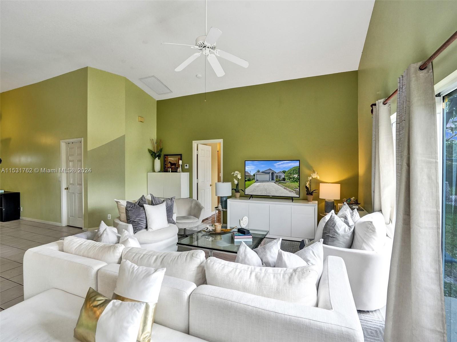Greenacres Greenacres, FL 33413 - Photo 20 of 61 a living room with furniture and a chandelier