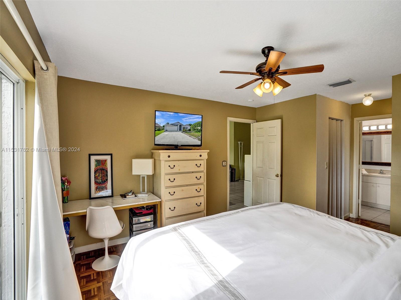 Greenacres Greenacres, FL 33413 - Photo 25 of 61 a bedroom with a bed and a chandelier