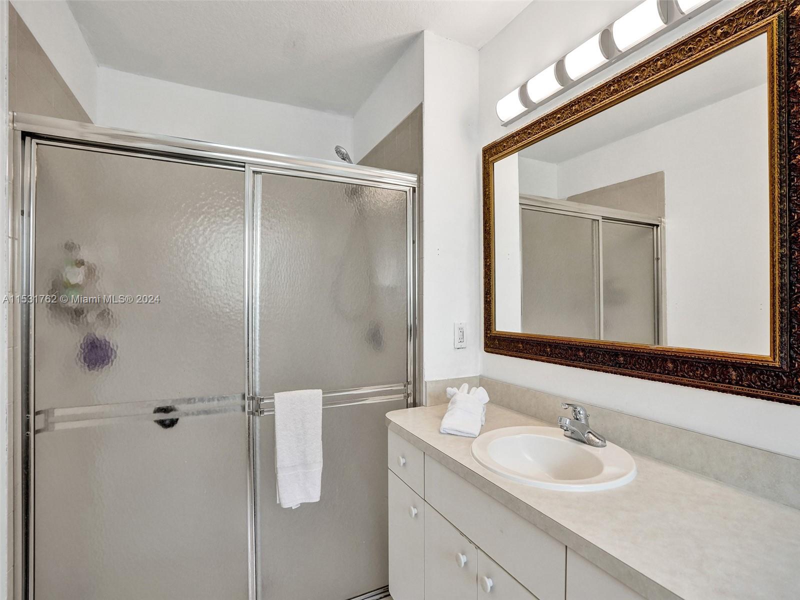 Greenacres Greenacres, FL 33413 - Photo 29 of 61 a bathroom with a granite countertop sink mirror and shower
