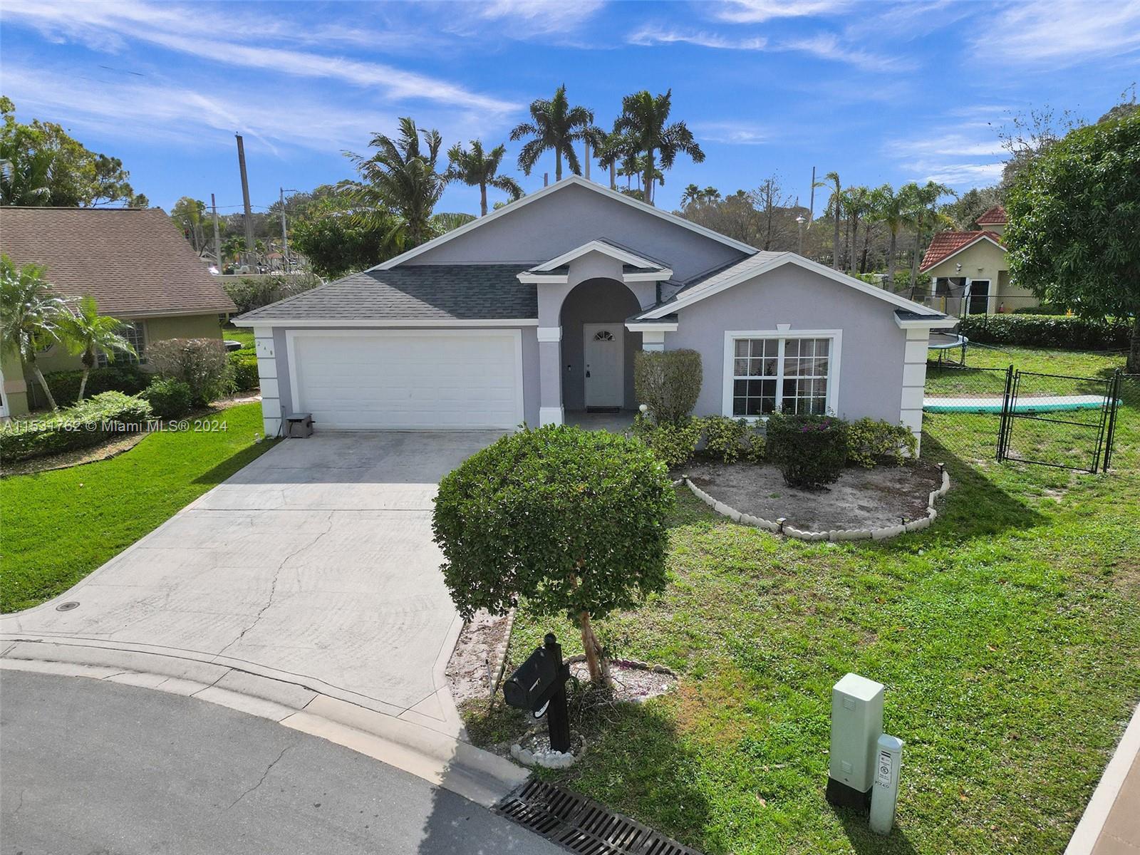 Greenacres Greenacres, FL 33413 - Photo 3 of 61 a front view of a house with garden