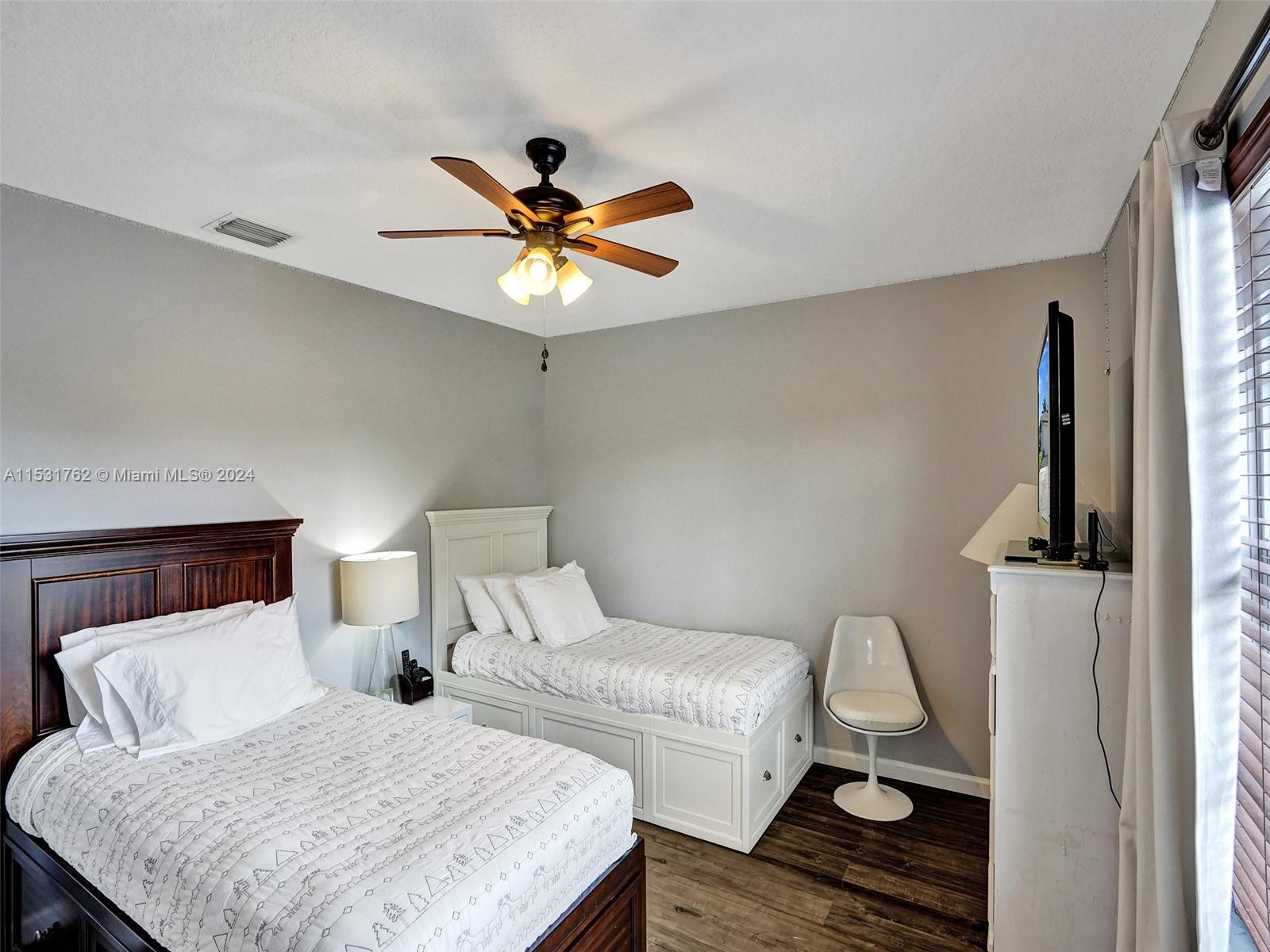 Greenacres Greenacres, FL 33413 - Photo 34 of 61 a bedroom with a bed and wooden floor