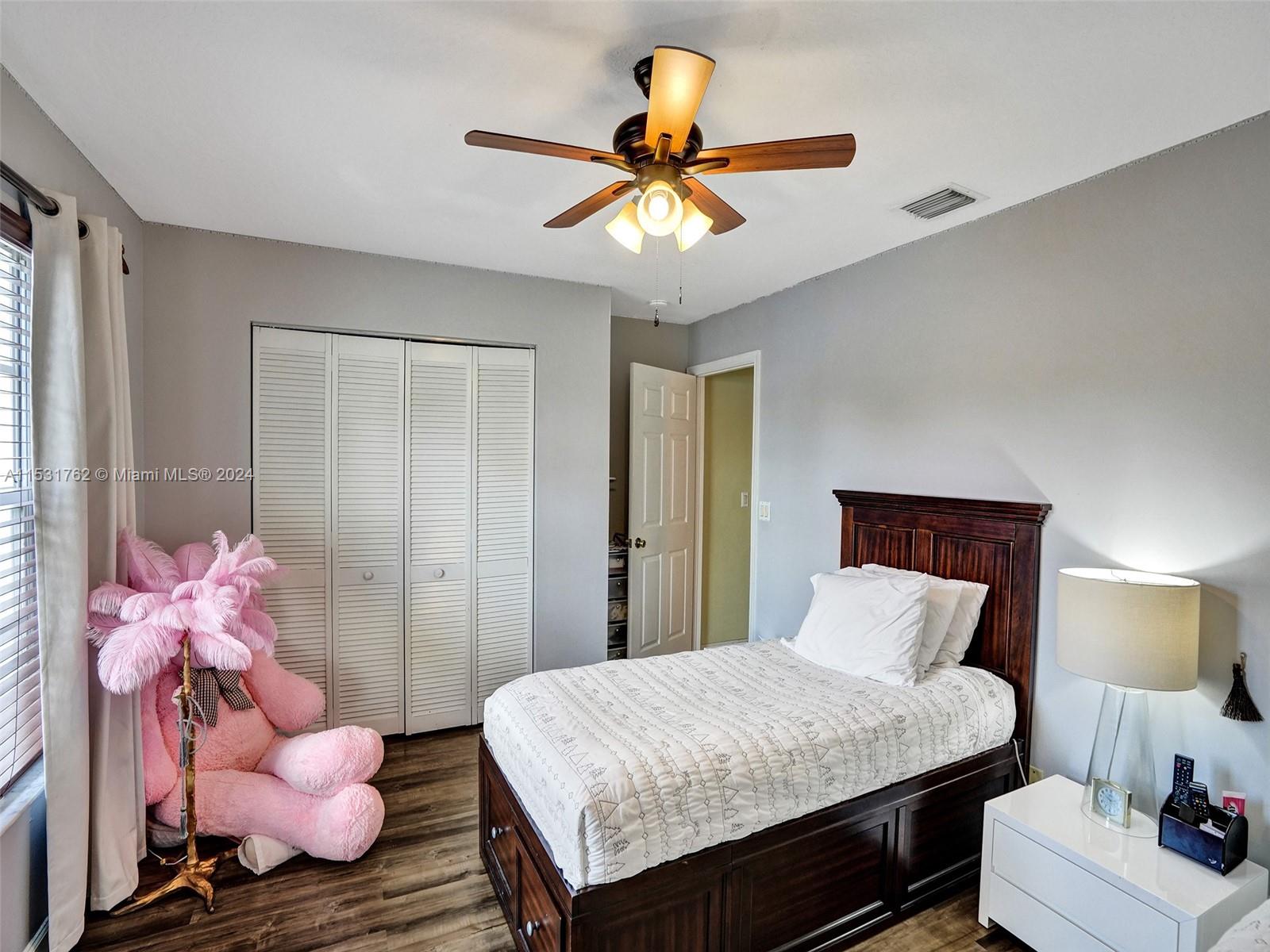 Greenacres Greenacres, FL 33413 - Photo 35 of 61 a bedroom with a bed and a chandelier