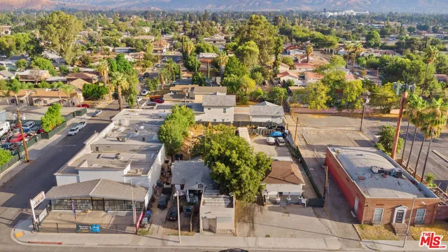an aerial view of a house with garden space and street view