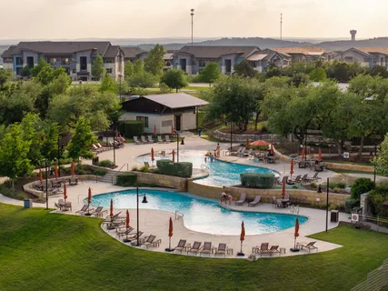 an aerial view of a house with swimming pool patio and outdoor seating
