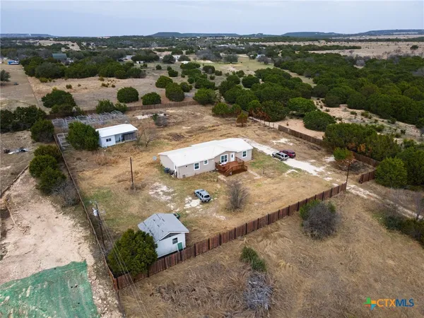 an aerial view of a house with a yard