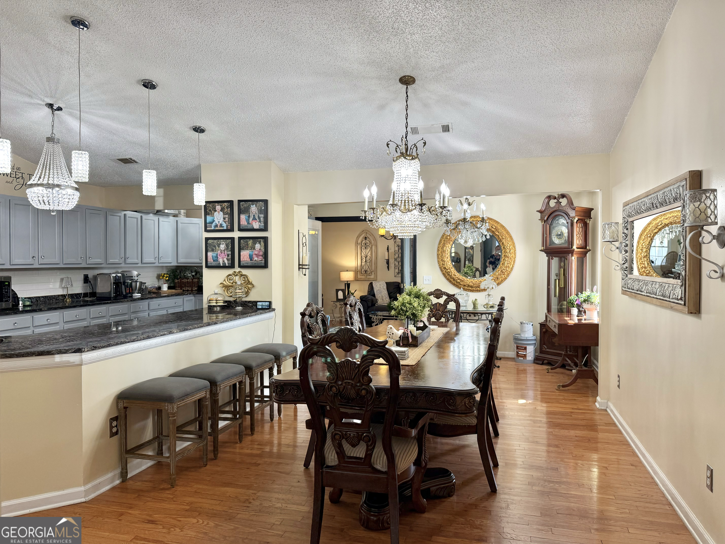 240 Ray Street Tallapoosa, GA 30176 - Photo 13 of 90 a view of a dining room and livingroom with furniture wooden floor a chandelier