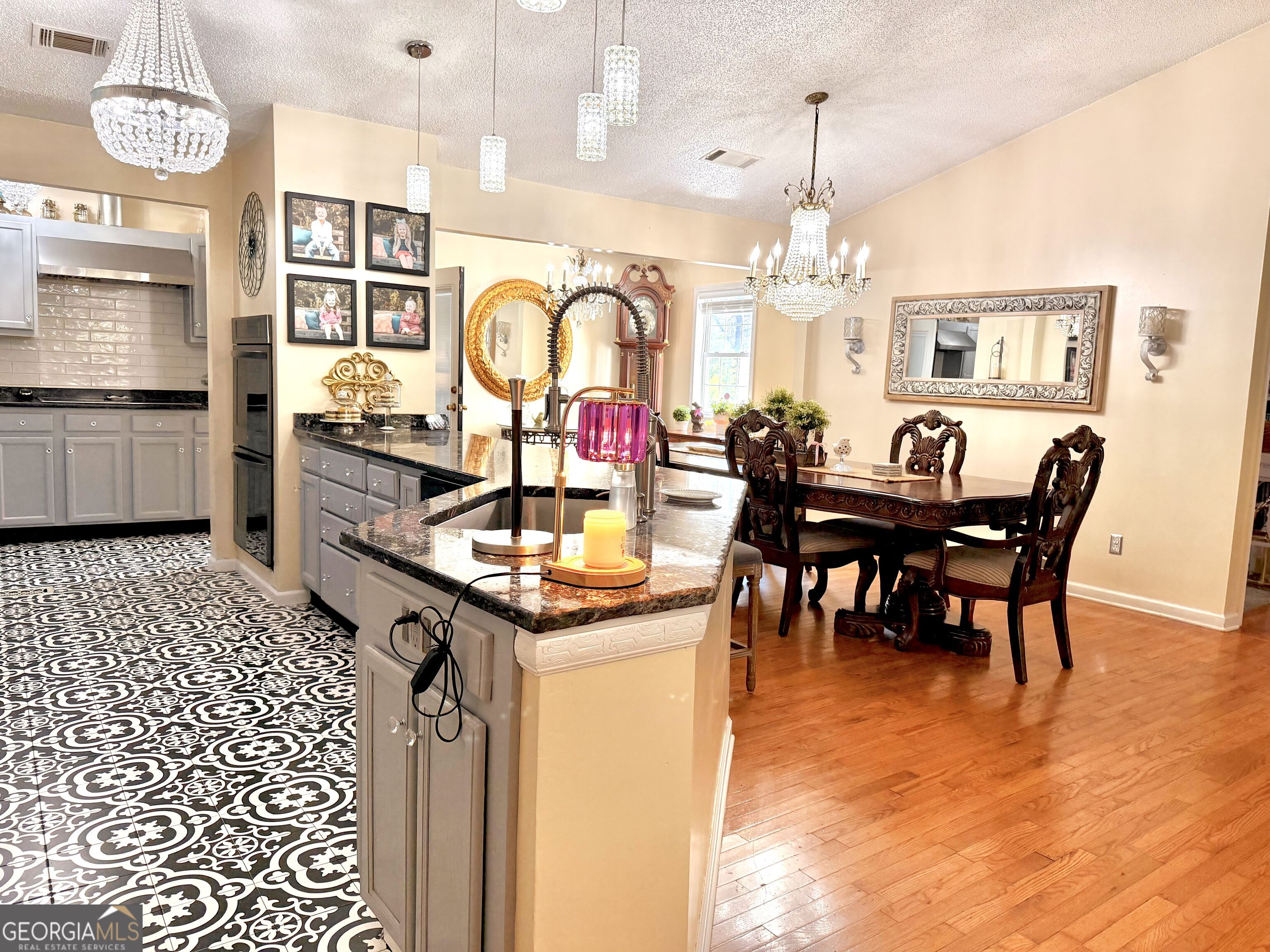 240 Ray Street Tallapoosa, GA 30176 - Photo 23 of 90 a kitchen with stainless steel appliances granite countertop a dining table chairs stove and cabinets