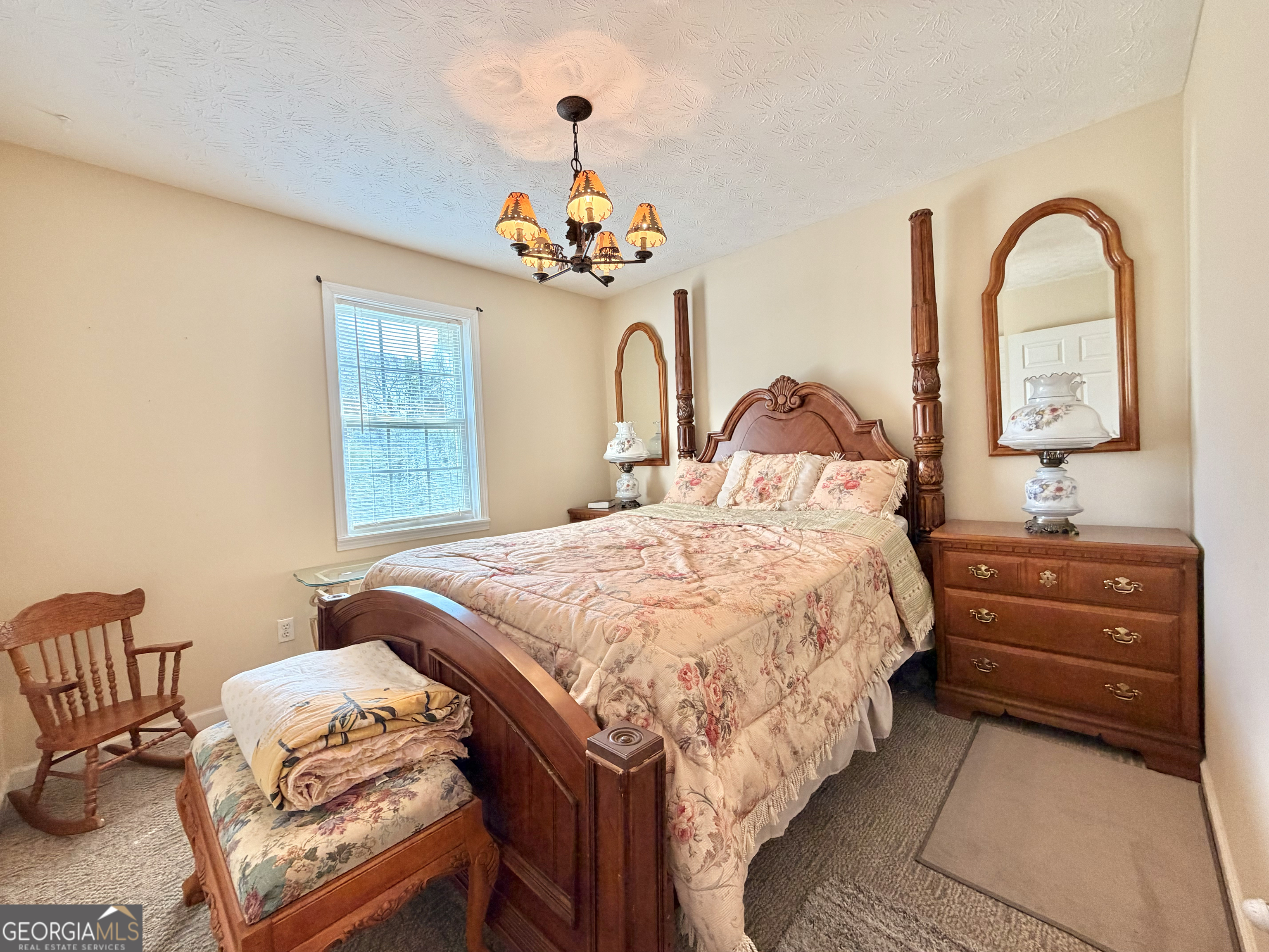 240 Ray Street Tallapoosa, GA 30176 - Photo 55 of 90 a bedroom with a bed and a chandelier