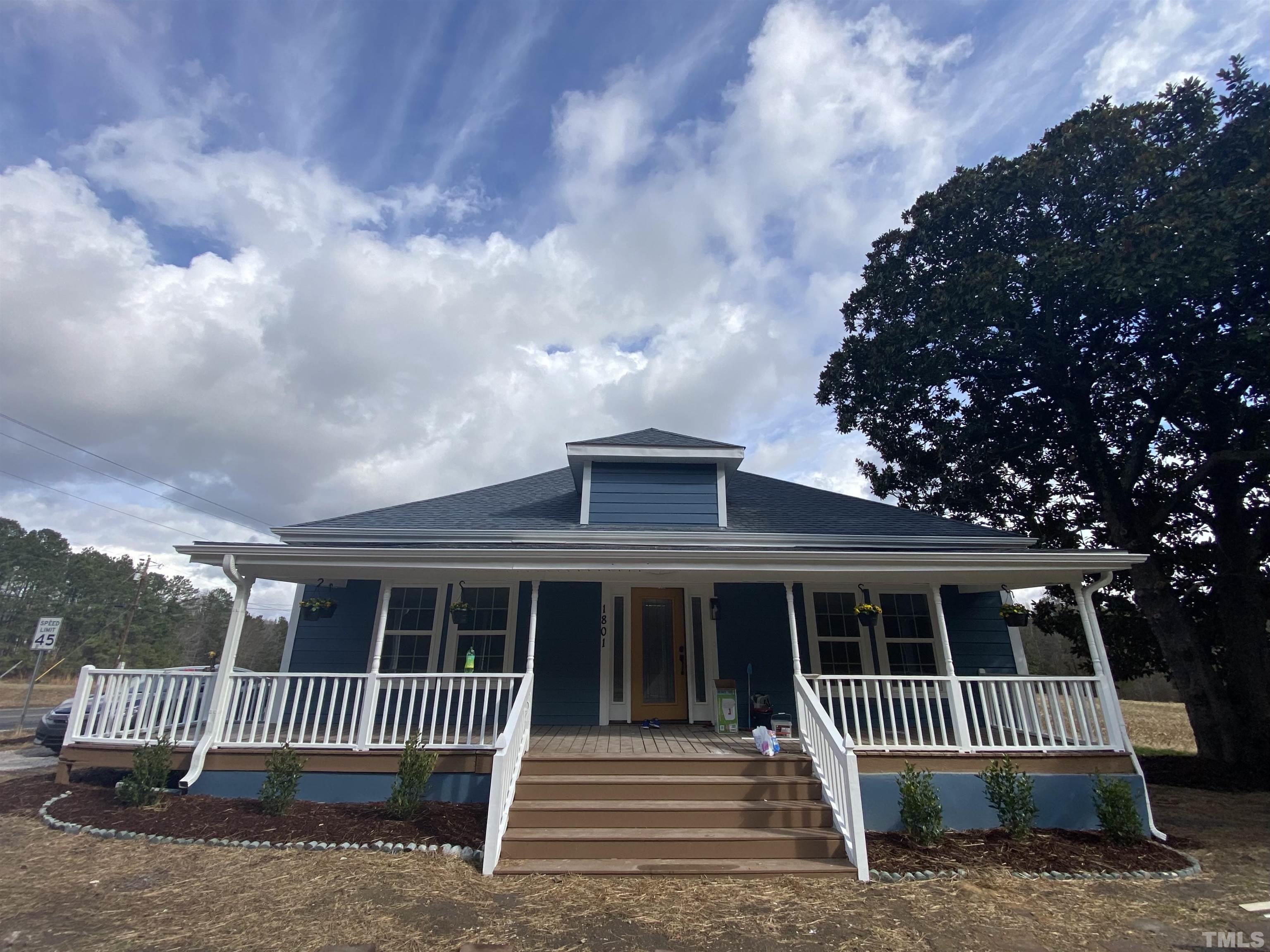 1801 East Garner Road Raleigh, NC 27610 - Photo 1 of 15 a front view of a house with a garden