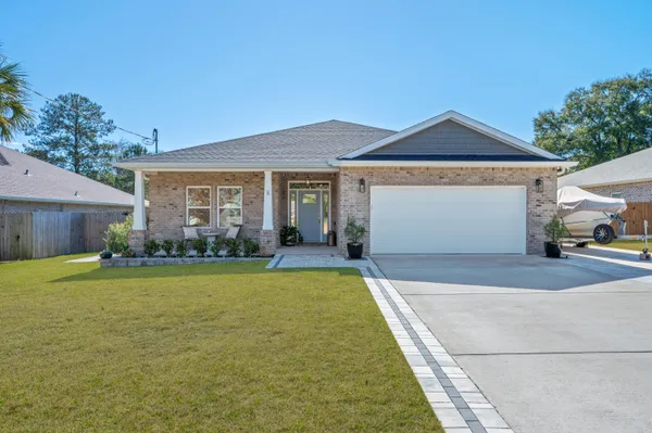 a front view of a house with a garden