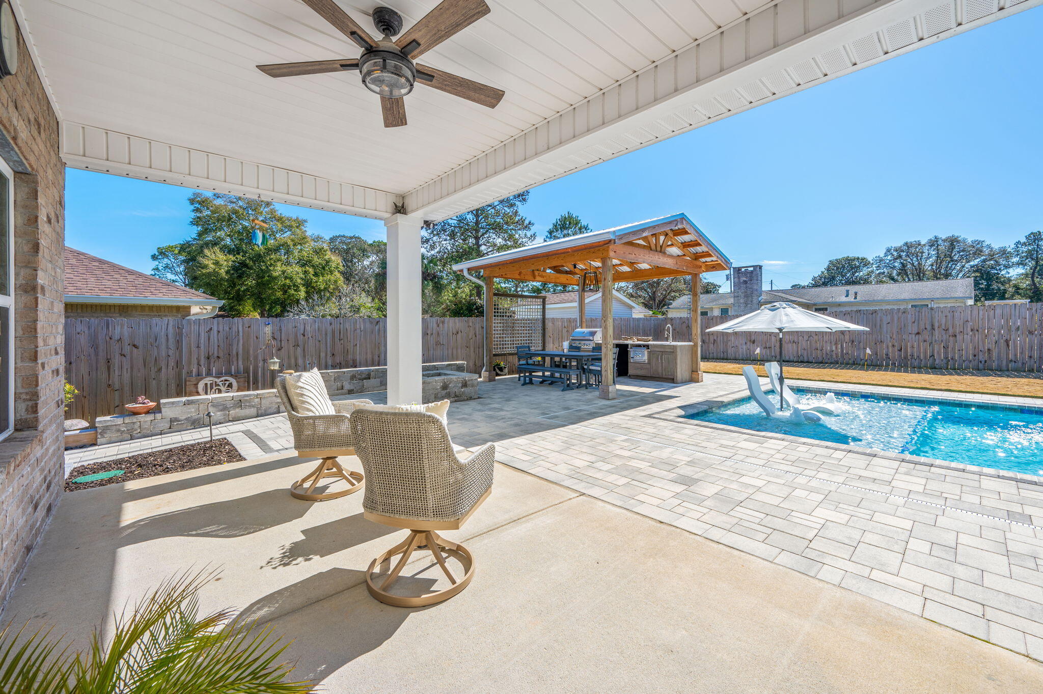 8 Maple Avenue Shalimar, FL 32579 - Photo 11 of 71 a view of a patio with couches chairs and a table and potted plants