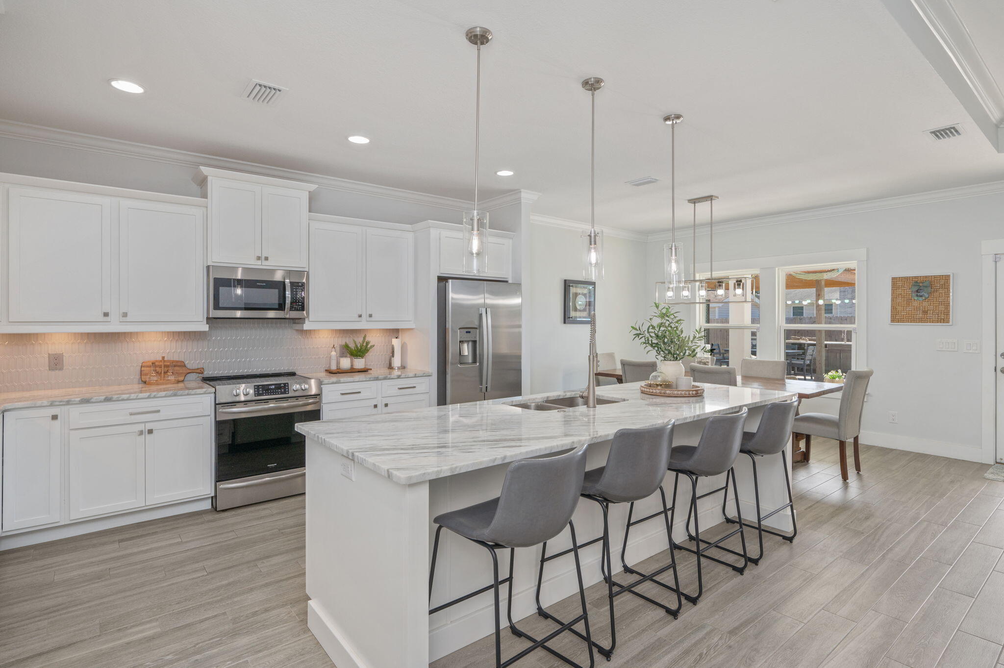 8 Maple Avenue Shalimar, FL 32579 - Photo 21 of 71 a kitchen with stainless steel appliances granite countertop a stove a refrigerator a kitchen island a sink and chairs
