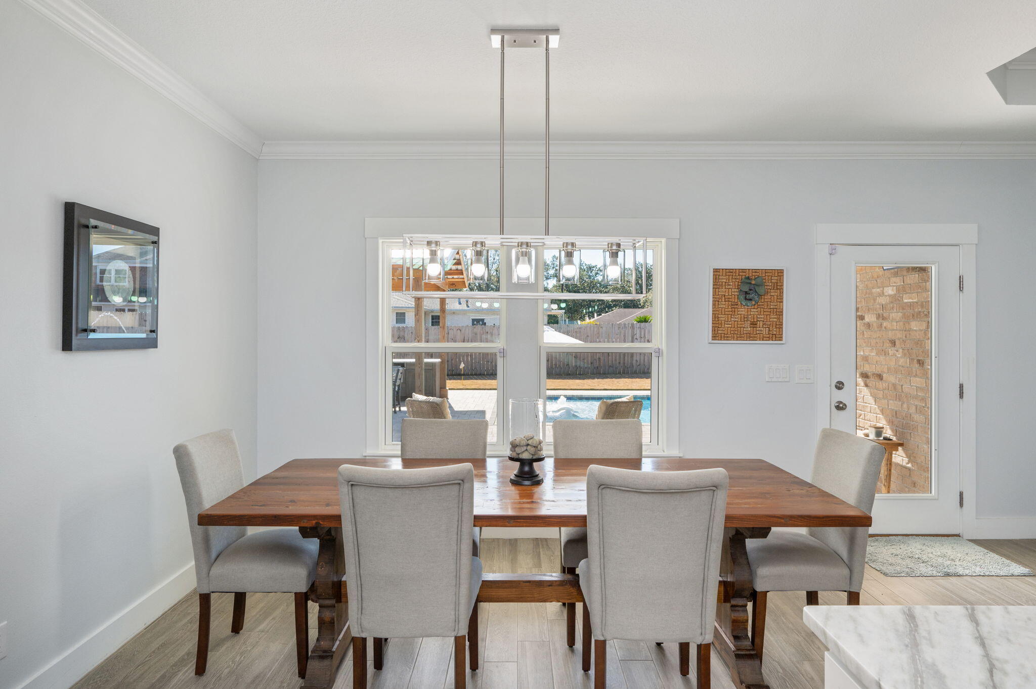 8 Maple Avenue Shalimar, FL 32579 - Photo 24 of 71 a view of a dining room with furniture a chandelier and wooden floor