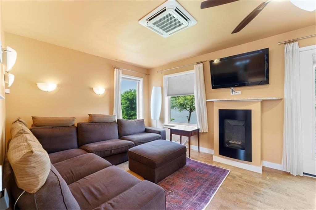 548 Penn Street Verona, PA 15147 - Photo 20 of 47 a living room with furniture a flat screen tv and a fireplace
