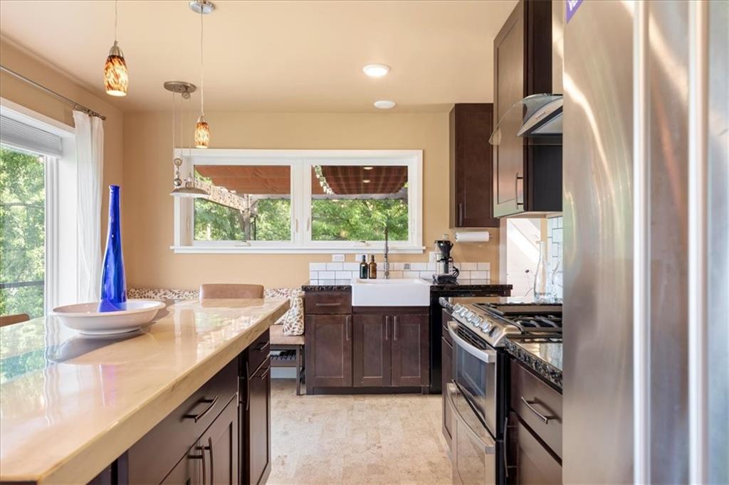 548 Penn Street Verona, PA 15147 - Photo 22 of 47 a kitchen with stainless steel appliances granite countertop a stove and a sink