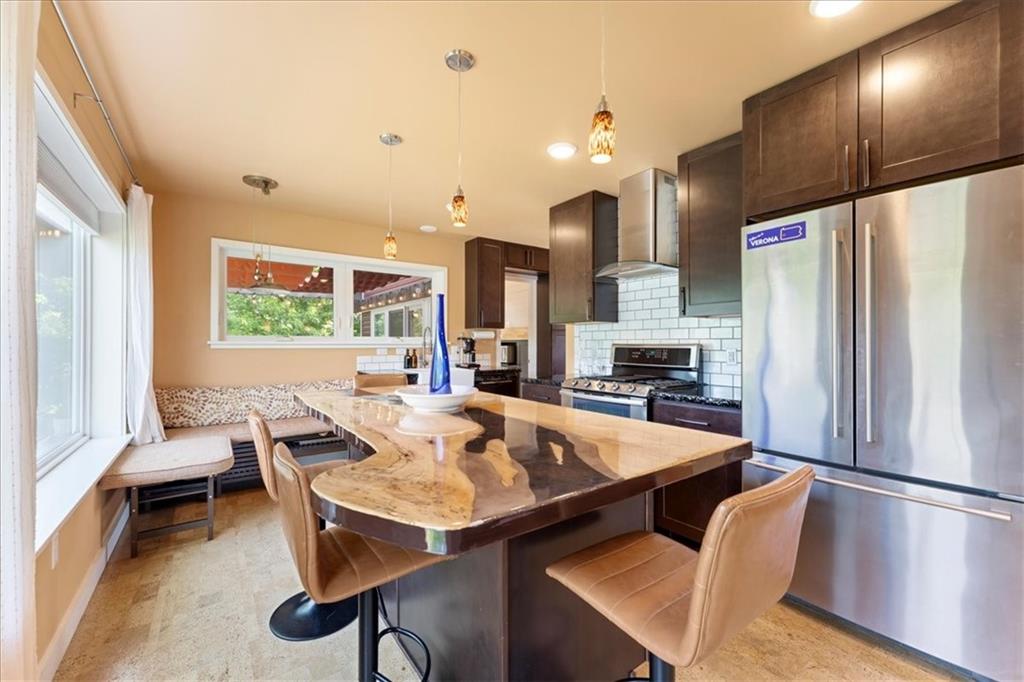 548 Penn Street Verona, PA 15147 - Photo 23 of 47 a kitchen with stainless steel appliances refrigerator dining table and chairs