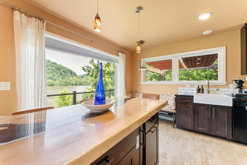 548 Penn Street Verona, PA 15147 - Photo 24 of 47 a kitchen with a sink and large windows