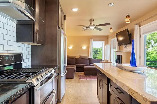 a kitchen with furniture a stove and a sink