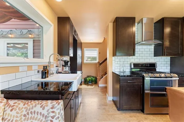 a kitchen with granite countertop a stove and a sink