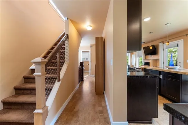 a view of entryway and hall with wooden floor