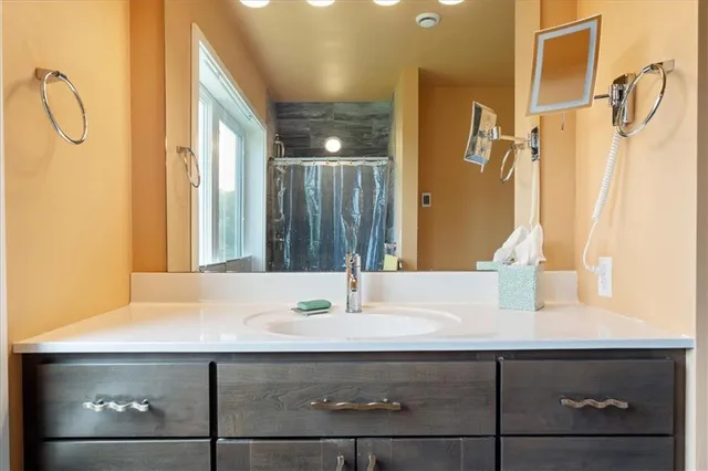 a bathroom with a sink and a mirror