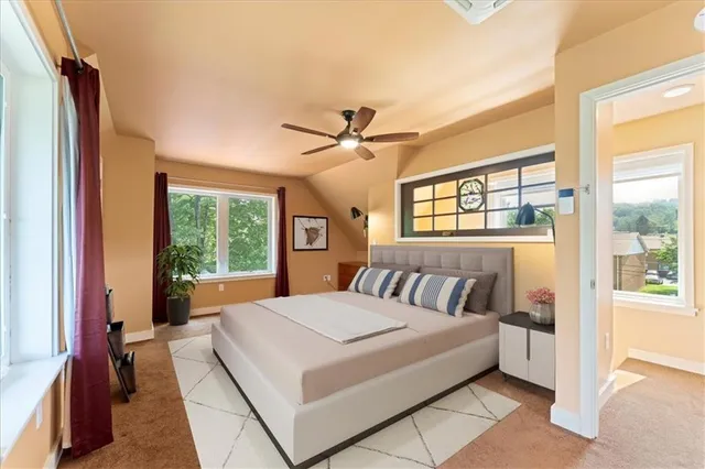 a bedroom with a large bed and a ceiling fan